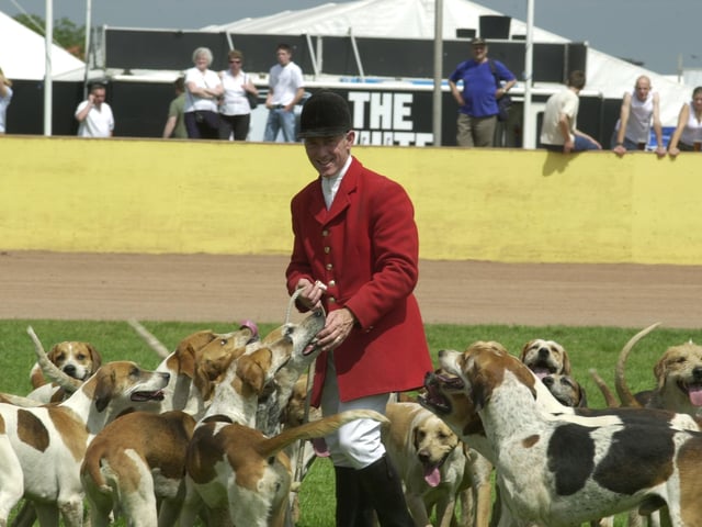 Members of the Fitwilliam Hunt with hounds in the showground.