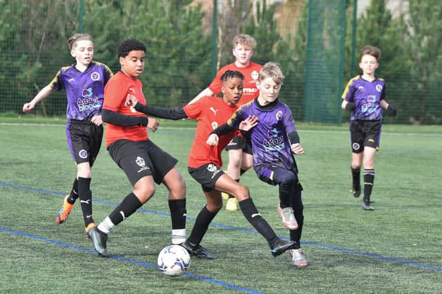 Action from Peterborough Regional Talent Centre  Under 12s (red) v Wisbech St Mary at Hampton Gardens School. Photo: David Lowndes.