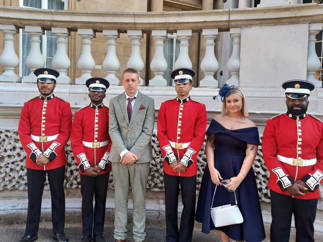 Peterborough's Up The Garden Bath's Dave Poulton and daughter Sienna Hayes-Palmer with Guards at the Royal Garden Party