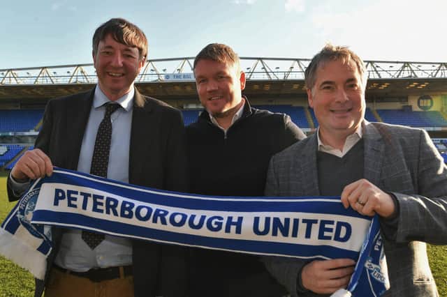 Co-owners Dr Jason Neale (left) and Stewart 'Randy' Thompson (right) flank Posh manager Grant McCann.