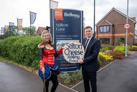 Sara Dunleavy, from the Stilton Cheese Rolling Festival committee, and Lewis Bowcutt, Senior Sales Advisor at Bellway, are pictured outside Bellway’s Stilton Gate development on North Street, where this year’s festival parade began. Bellway donated £300 to help stage the event.