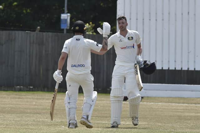 Josh Smith (right) and Chris Milner celebrate their record-breaking stand. Photo: David Lowndes.