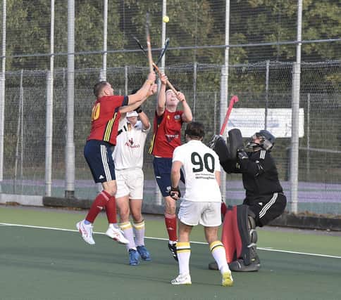 Rare hockey aerial action from City of Peterborough (red) v Nottingham University. Photo: David Lowndes.