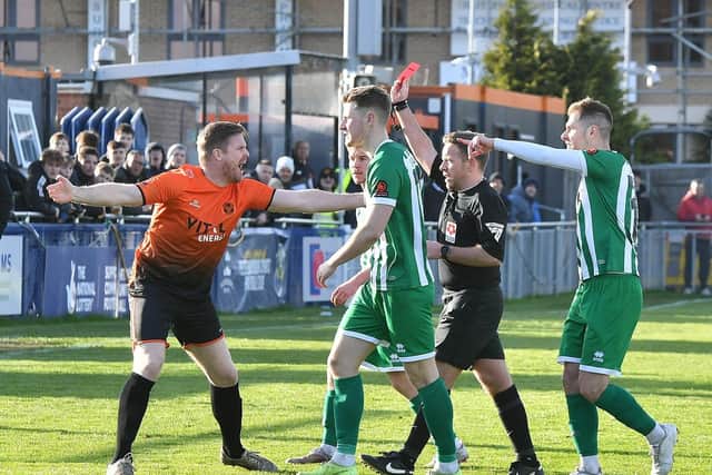 Peterborough Sports joint manager Michael Gash (orange) doesn't look happy with a red card for teammate Ryan Fryatt. Photo David Lowndes.