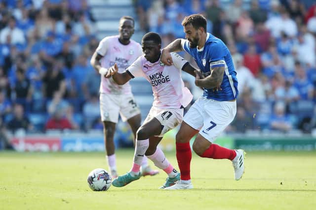 Kwame Poku of Peterborough United battles with Marlon Pack of Portsmouth at Fratton Park earlier this season. Photo Joe Dent/theposh.com.