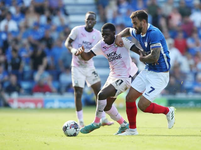 Kwame Poku of Peterborough United battles with Marlon Pack of Portsmouth at Fratton Park earlier this season. Photo Joe Dent/theposh.com.
