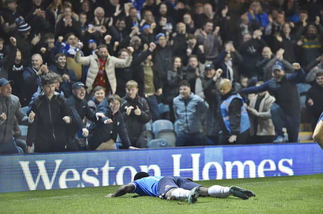 Kwame Poku just after his knee slide to celebrate putting Posh 3-0 up against Sheffield Wednesday. Photo: Joe Dent.