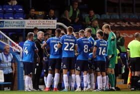 Peterborough United Manager Grant McCann gives out instructions to his players during a break-in play.