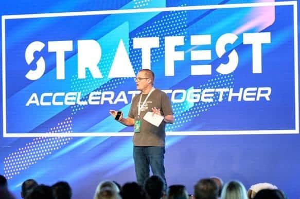 Speaker and author, Jim Lawless, leading the 18th anniversary celebrations for Peterborough's Compare the Market at the Silverstone race track.
