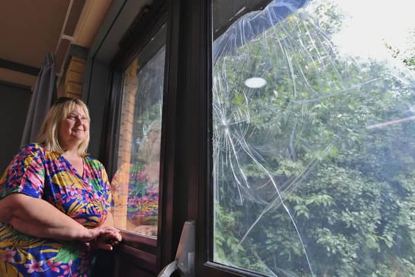 Tracy Chapman looking at vandalism to windows at the Orton Wistow community centre