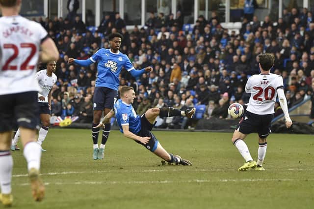 Posh midfielder Jack Taylor slips as he shoots against Bolton. Photo: David Lowndes.