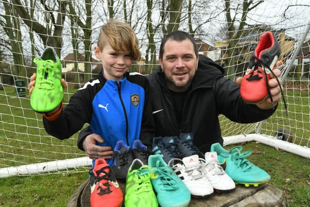Lewis Brampton and son, George. Lewis is hoping his kit sharing scheme will help ensure youngsters across the region get to play football with decent boots, shin pads and other necessities.