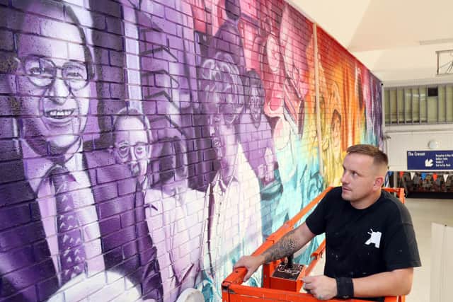Nathan Murdoch designed the mural by colour transition, with vintage photographs in purple and modern day in warmer tones.