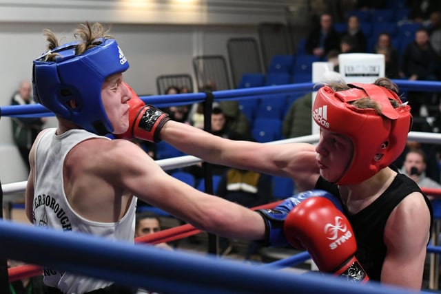 PPBC boxer (blue) Terry  McGinley v Harry James during a Peterborough Police Boxing Tournament at Queen Katharine Academy.