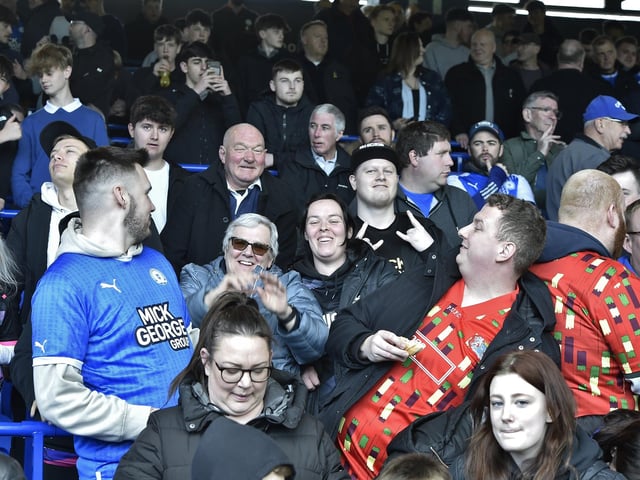 Peterborough United fans are pictured watching the crucial win over Derby County.