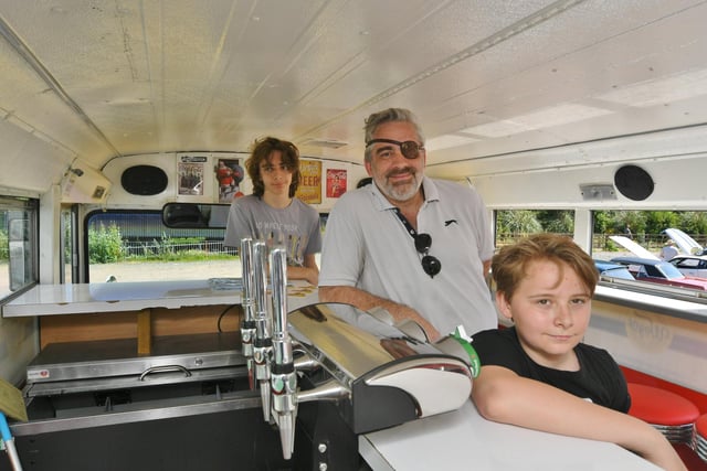 Christopher, Ricky and Chase Stapleton looking around a US school bus now converted in to a mobile bar
