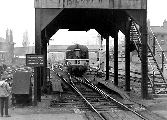 An evocative old shot of a diesel engine approaching Peterborough East station, with Town Bridge in the background.