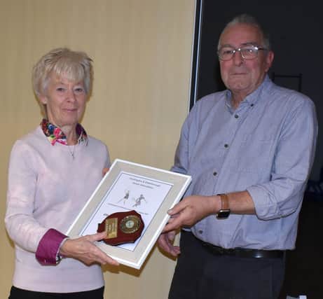 Nicky Keir collects an award on behalf of City of Peterborough Tennis Cub at from league chairman Dennis Vincent. Photo: Geoff Smith.