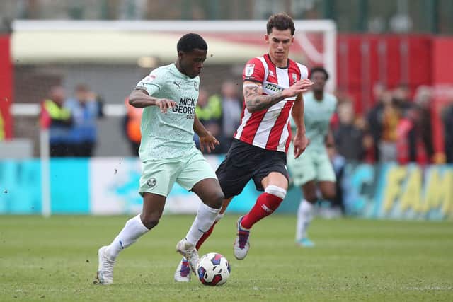 Kwame Poku of Peterborough United in action with Lewis Montsma of Lincoln City. Photo: Joe Dent/theposh.com.