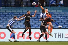 Will Norris of Peterborough United punches the ball whilst under pressure against Sheffield Wednesday. Photo: Joe Dent/theposh.com.