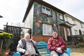 Gordon Squires pictured with city artist Nathan Murdoch sitting outside the painted house (image: David Lowndes).