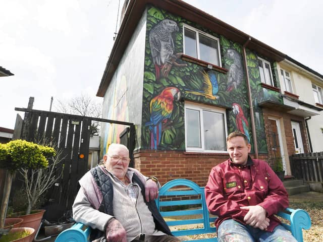 Gordon Squires pictured with city artist Nathan Murdoch sitting outside the painted house (image: David Lowndes).
