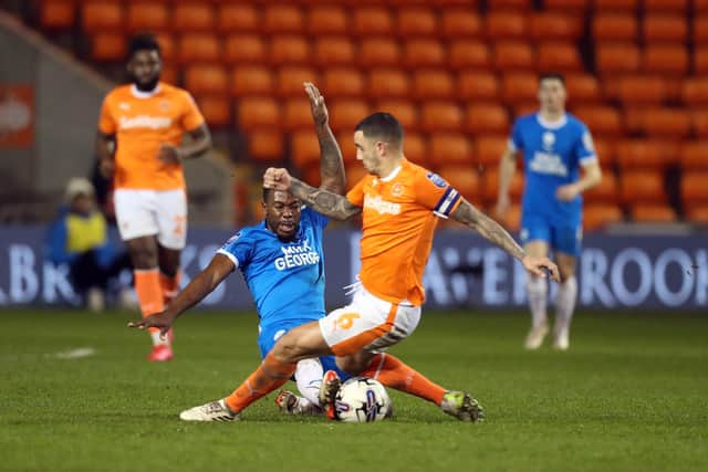 Posh midfielder Jeando Fuchs makes a crunching tackle at Blackpool. Photo: Joe Dent/theposh.com.