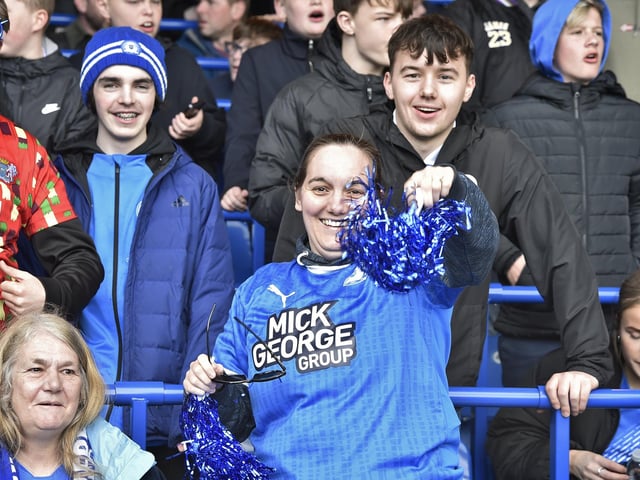 Peterborough United fans are pictured watching the crucial win over Derby County.