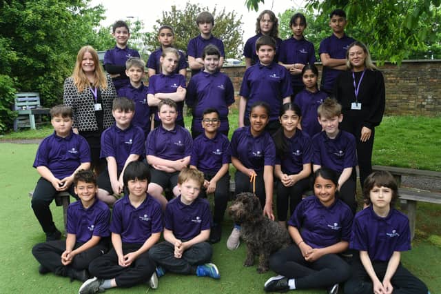 Bishop Creighton school year 6 leavers with their school dog Arthur.