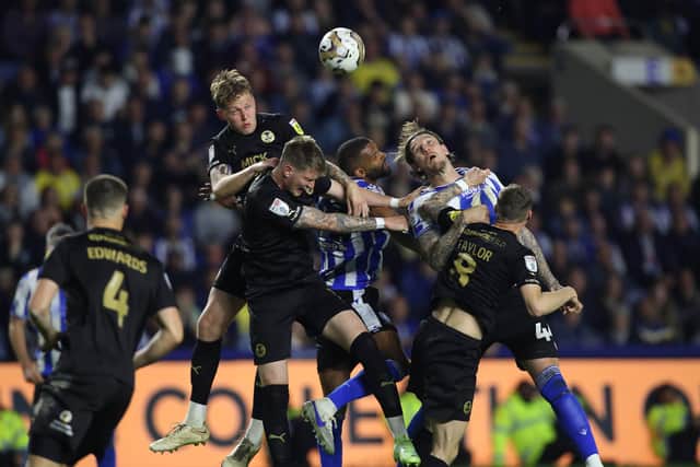 Posh centre-back Frankie Kent jumps highest in this aerial battle against Sheffield Wednesday. Photo: Joe Dent/theposh.com