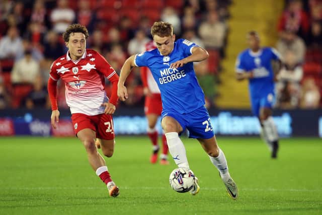 Archie Collins of Peterborough United in action with Callum Styles of Barnsley. Photo: Joe Dent/theposh.com