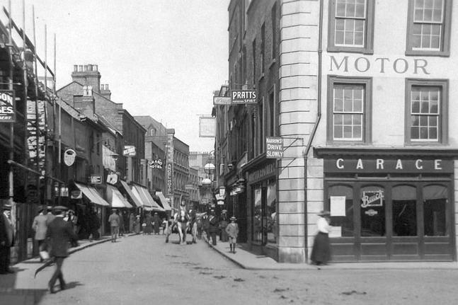 An undated image showing the southern (less commonly photographed) end of the street, with Murketts Garage on the right.
