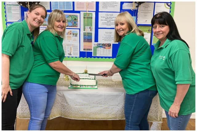 Members of the team celebrate the anniversary