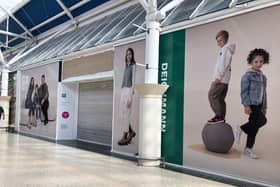 The hoardings across the front of the new Deichmann store at the Serpentine Green Shopping Centre in Hampton,  Peterborough.