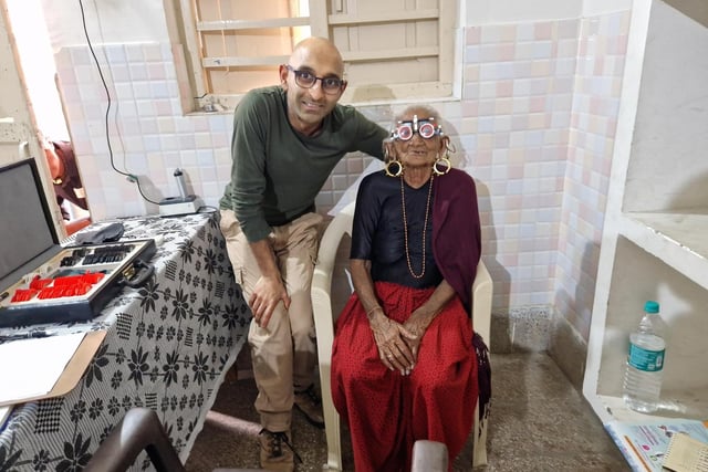 Chintu Patel,  ophthalmic director for Peterborough Specsavers, with one of his patients during four days in India  providing essential optical care.