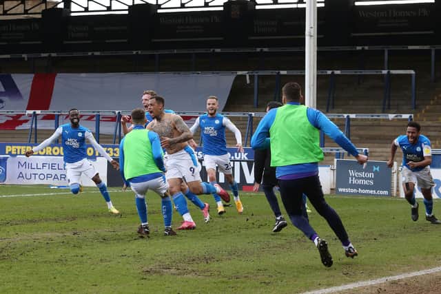 Jonson Clarke-Harris (shirtless) has just converted the penalty against Lincoln City that sealed promotion for Posh in May, 2021.  Photo: Joe Dent/theposh.com