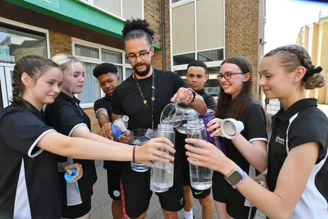 Pupils at Nene Park Academy refilling their water bottles with  Head of PE Aaron Kennedy.