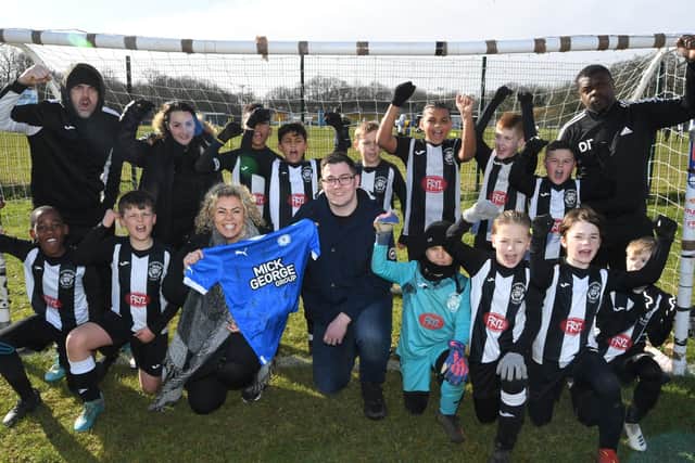 Peterborough Lions FC with their sponsors Zoe Glover and Kieran Connolly from Peterborough Progress Health PLC