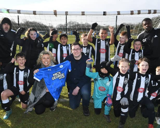 Peterborough Lions FC with their sponsors Zoe Glover and Kieran Connolly from Peterborough Progress Health PLC