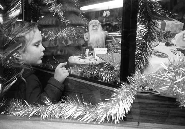 Tracey Johnson (nee Beard) aged 3 looking at the cakes in the shop window