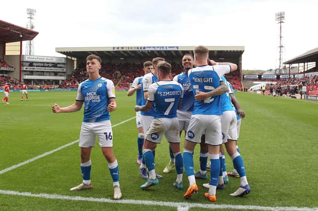 Harrison Burrows leads the Posh celebrations after a goal at Barnsley.