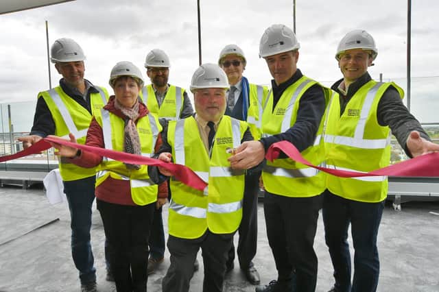 Steve Cassidy, managing director of Hilton UK, front right, with Peterborough City Council leader Cllr Wayne Fitzgerald cutting the ribbon at the topping out ceremony at the Hilton Garden Inn in Peterborough.