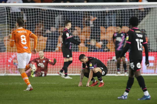Oliver Norburn  cuts a dejected figure as Blackpool celebrate a goal against Posh in December, 2021. Photo: Joe Dent/theposh.com.