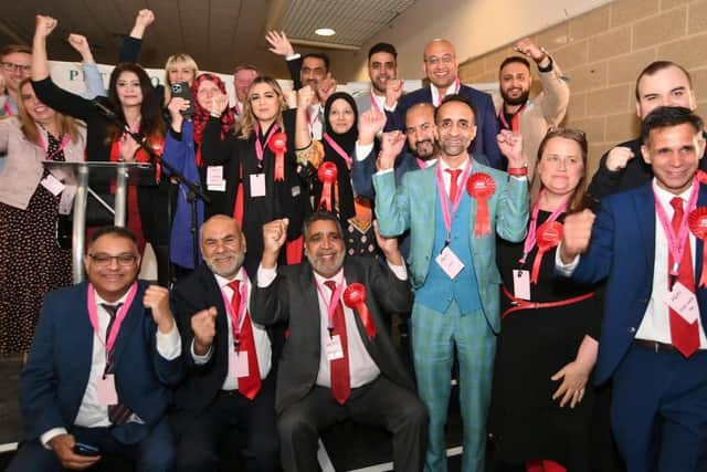 The Labour Group pictured at the Peterborough City Council local election count at the East of England Arena on 5 May  - with Labour Group leader Shaz Nawaz wearing light blue suit (image: David Lowndes)