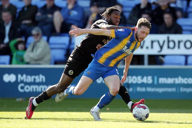 Ricky-Jade Jones of Peterborough United puts pressure on Matthew Pennington of Shrewsbury Town. Photo: Joe Dent/theposh.com.