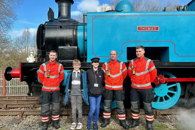Schoolboy railway enthusiasts Harry Cowley and Oliver Walker pose for pics with firefighters.