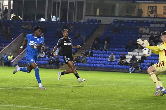Kyrell Lisbie goes for goal for Peterborough United against Aston Villa Under 21s in the Vertu Trophy. Photo: David Lowndes.