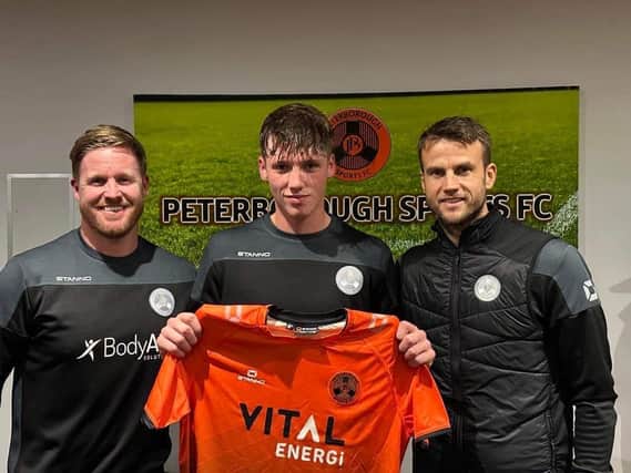 Oisin Gallagher with joint managers Michael Gash (left) and Luke Steele (right) when he signed for Peterborough Sports. Photo: Darren Wiles.