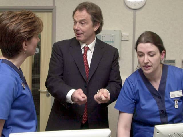 Prime Minister Tony Blair talks to Clinical Nurse Managers Louise Molina (right), and Sarah King during the official opening  of the first NHS walk-in centre at Peterborough,