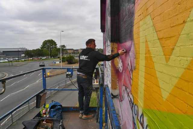 Celebrated street artist Nathan Murdoch said he was well looked after as he worked on his latest mural on Gladstone Street. “I ate for free every day because people just bought me food every day.”